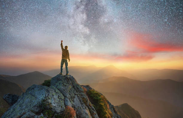 istock Silhouette of a champion on mountain peak. Active life concept 915024748