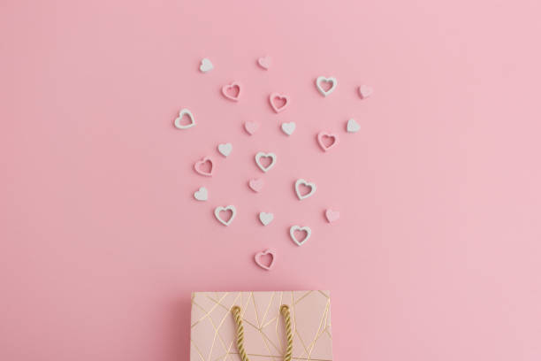 istock Hearts flying out of a valentines gift bag 915025012