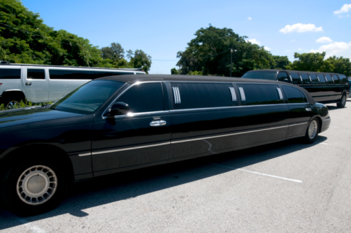 Brooklyn, New York, NY, USA - July 6th 2022: Black stretched limousine in front of factory building