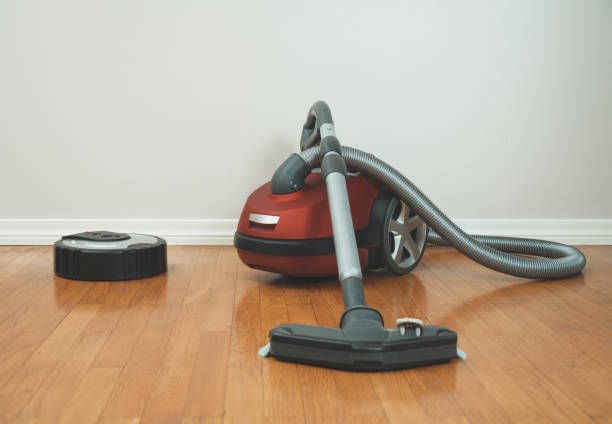 istock Robotic vacuum cleaner vs Vacuum cleaner. 915032662