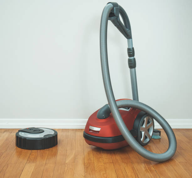 istock Robotic vacuum cleaner vs Vacuum cleaner. 915032666