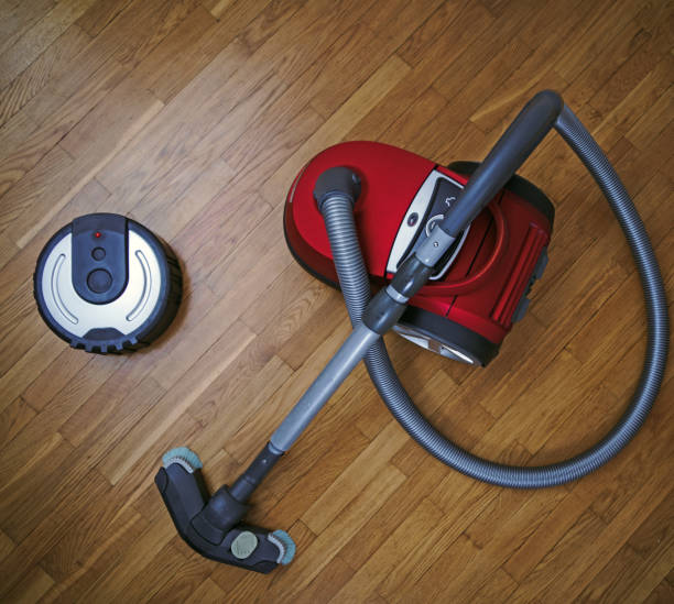 istock Robotic vacuum cleaner vs Vacuum cleaner. 915032678