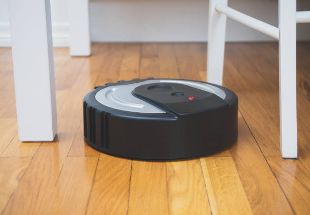 istock Black robotic vacuum cleaner on the floor. 915032702