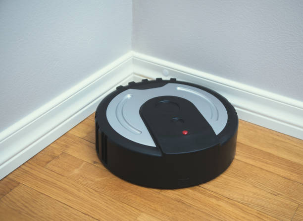 istock Black robotic vacuum cleaner on the floor. 915032742