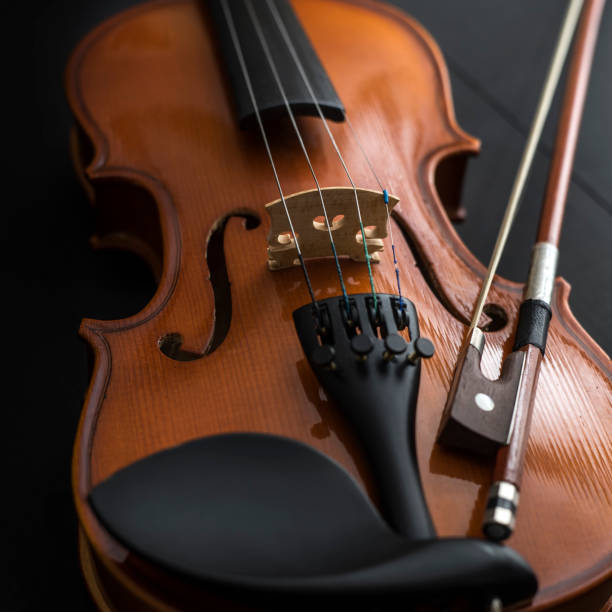 istock old Violin with bow on wooden table 915038272
