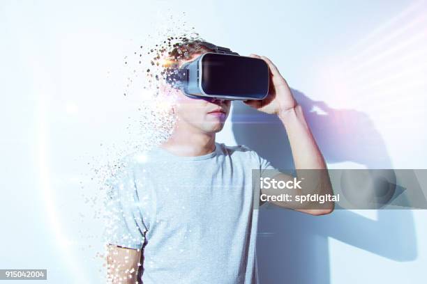 Young Man Wearing Virtual Reality Goggles In Modern Coworking Studio Smartphone Using With Vr Headset Horizontal Stock Photo - Download Image Now