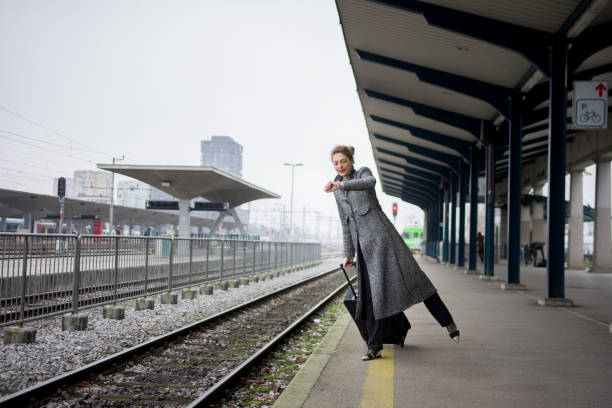 Woman waiting for the train and checking the time