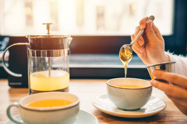 istock woman drink hot orange tea in cafe 915044868