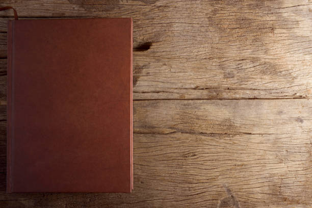 istock Brown book on wooden table. 915046344