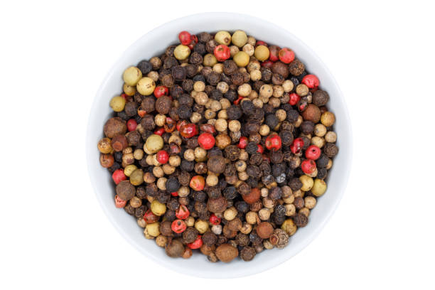 istock Peppercorns pepper peppercorn from above bowl isolated on white 915052864