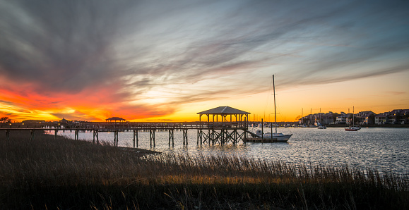 A dramatic sunset rises above residential boat docks at Folly Beach, SC.