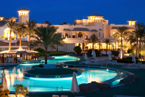 Tourist resort with pool, hotels, restaurants, spa, playground in Egypt. Taken at dusk with a tripod to align the artificial light and the brightness of the evening blue sky.