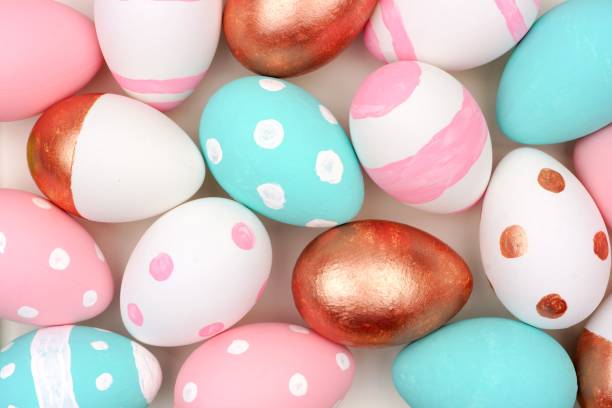 istock Pink, turquoise, rose gold and white Easter egg background 915056860