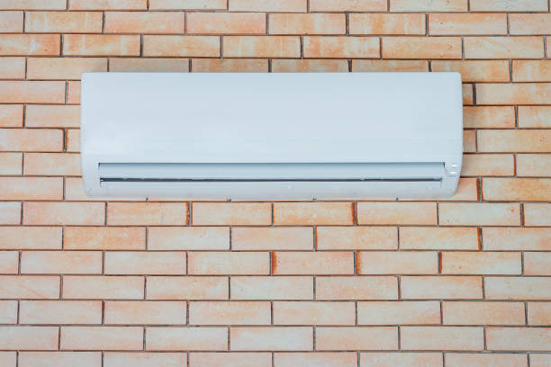 Air conditioner on a brick wall stock photo