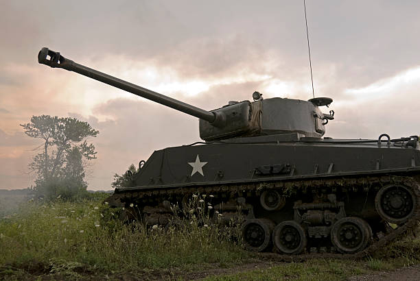 istock Mark IV Sherman tank driving through field on cloudy day 91506659