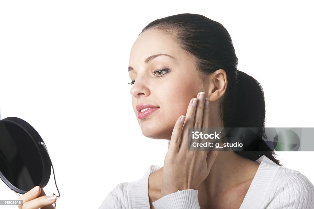 Joven mujer sonriente aplicar cosméticos aislados con espejo para maquillaje, - Foto de stock de Espejo libre de derechos
