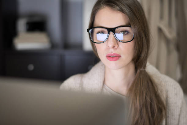 istock Business analyst in eyeglasses working late 915070732