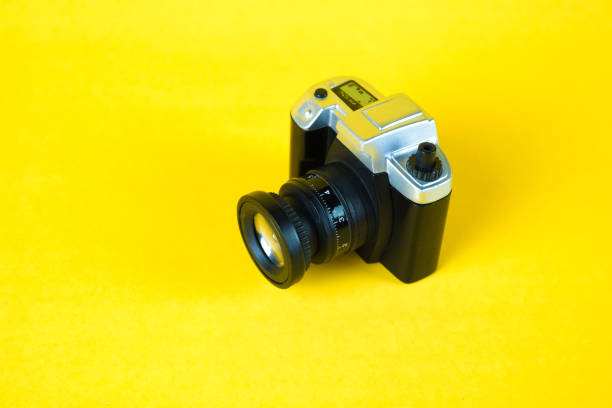 istock Mini camera toy on yellow background, copy space for add text. 915071542