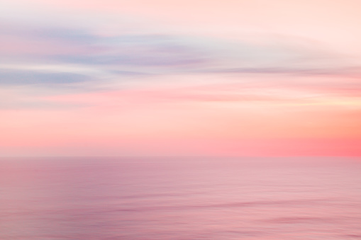 istock Defocused sunrise sky and ocean nature background with blurred panning motion. 915074748