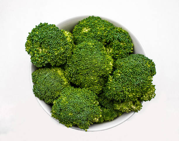 istock Closeup of Fresh Green Broccoli on a white background 915079260