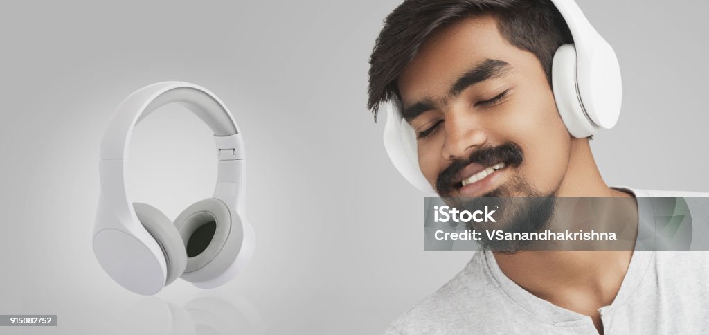 Young man enjoying music in headphones Young man enjoying music in headphones and composed like advertising concept. Listening Stock Photo