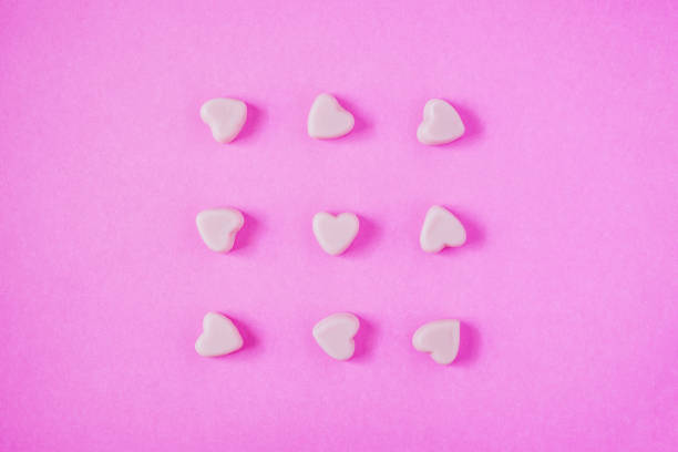 istock valentine candy hearts shape on pink background 915082946