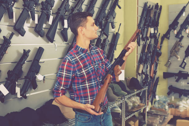 istock Male customer is choosing air-powered gun 915086694