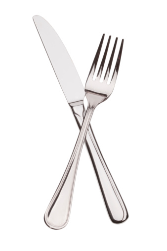The crossing fork and knife on white background
