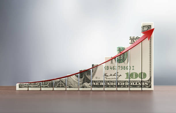 istock Money Chart And A Red Arrow On Wood Surface Over Defocused Background 915086818