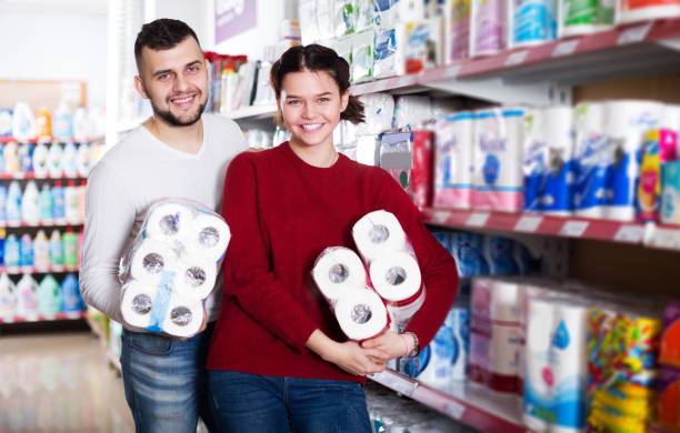 Man and girl selecting toilet paper