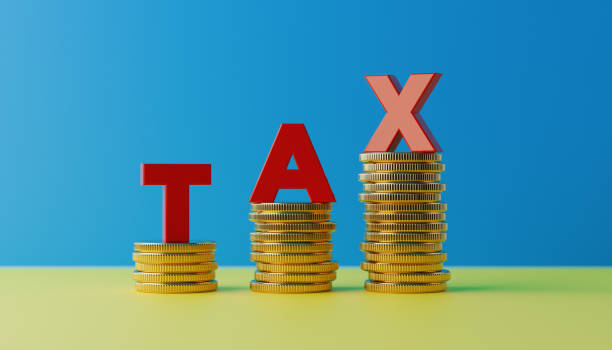 istock Red Letters Standing On Coin Stacks Forming Tax Word 915087236