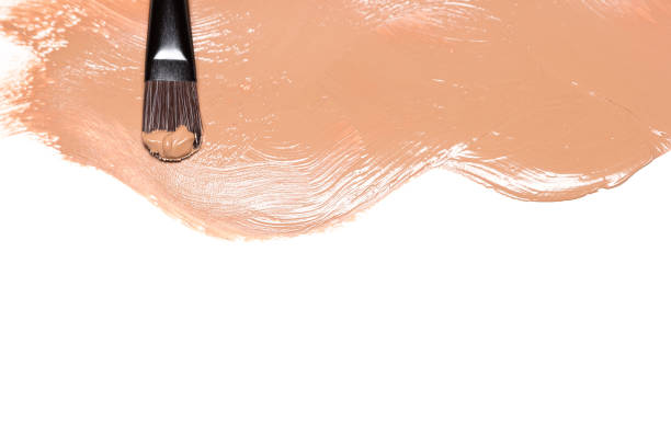 istock Make-up brush and smeared fluid foundation with copy space 915090368