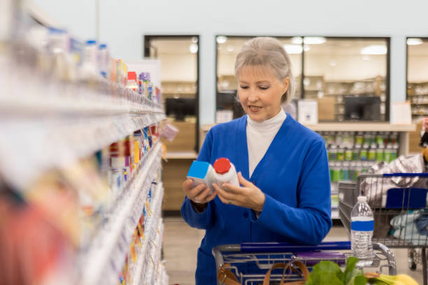 istock Senior woman compares two over the counter medications 915093084