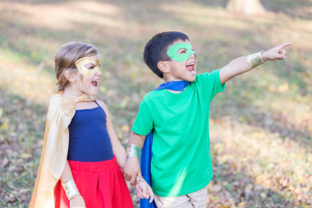 istock Kids dressed as superheroes playing together 915093220