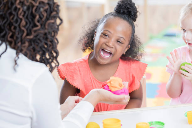 istock Excited little girl plays with modeling clay 915093546