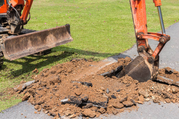 istock Digger machine operate for digging soil and repair road in the public park 915093794