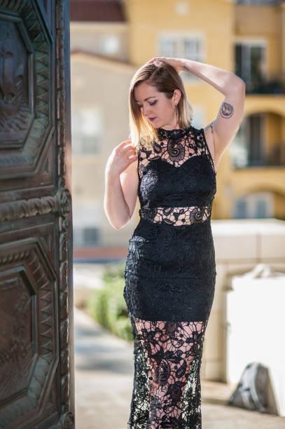 istock Rustic door revealing model in evening gown. 915095444