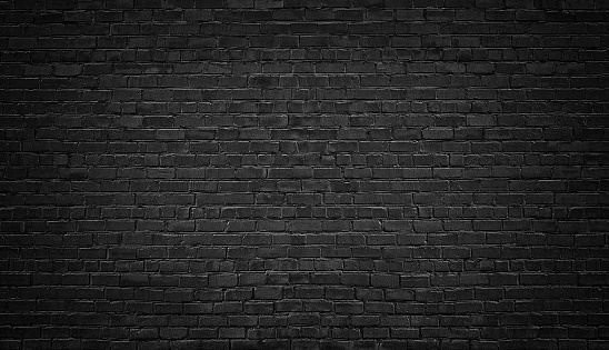 Fondo de pared de ladrillos negros. albañilería oscuro textura photo