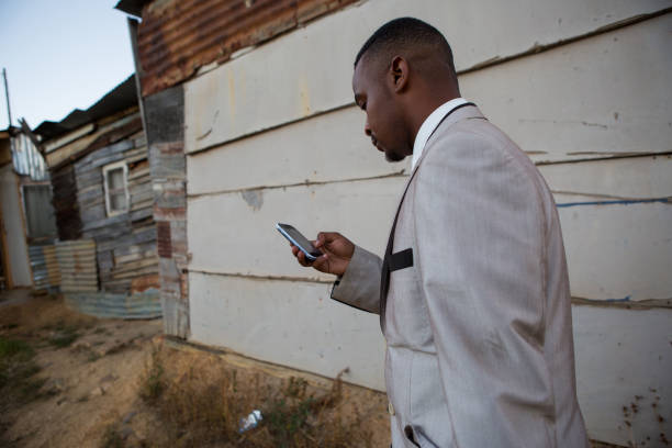 istock Business man walking to work and checking his phone 915101894