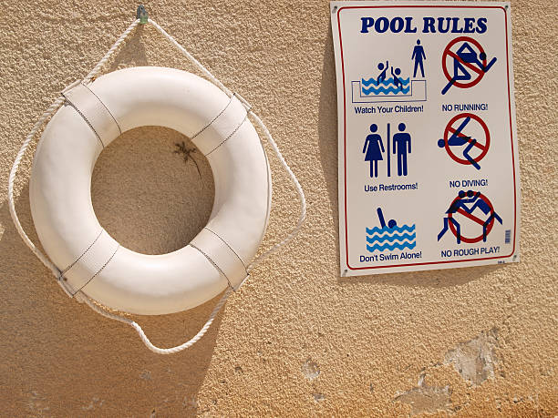 a swimming pool sign and a safety equipment