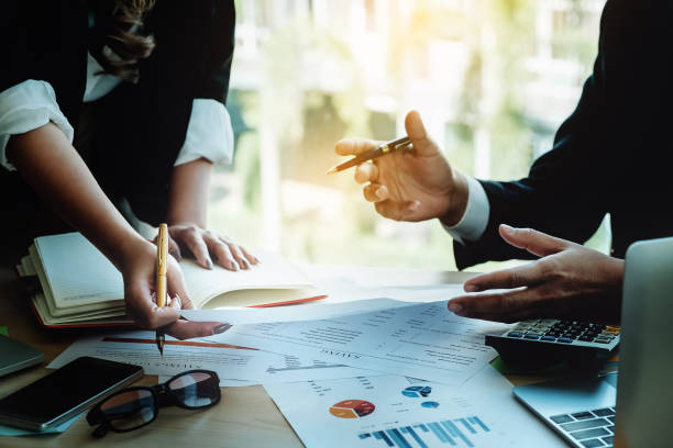 istock CEO Explain analyze the company's sales plan to partnership with use computer laptop, mobile phone, financial document and calculator in 915102480