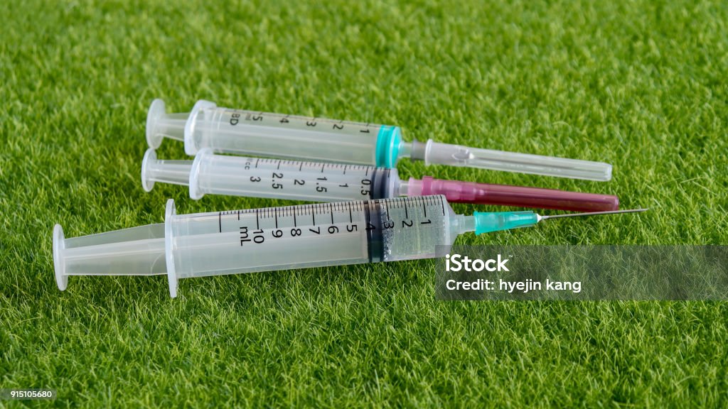 Syringing Turf Three Disposable Syringes At Lawn Stock Photo - Download Image Now ...