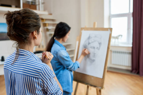 istock Art teacher estimating work of student 915106008