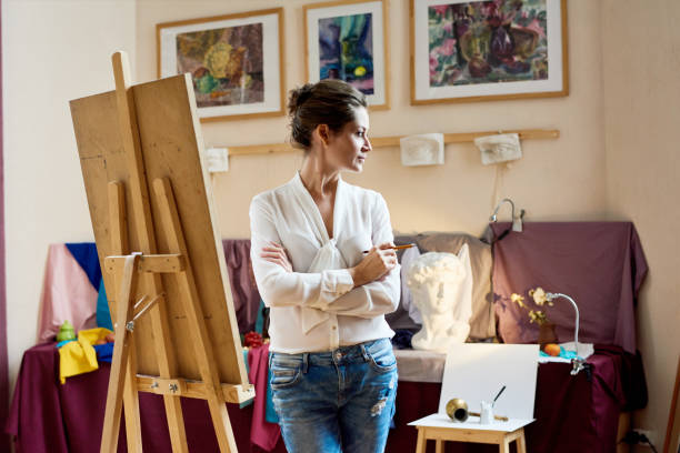 istock Dreamy artist finding inspiration in studio 915106202