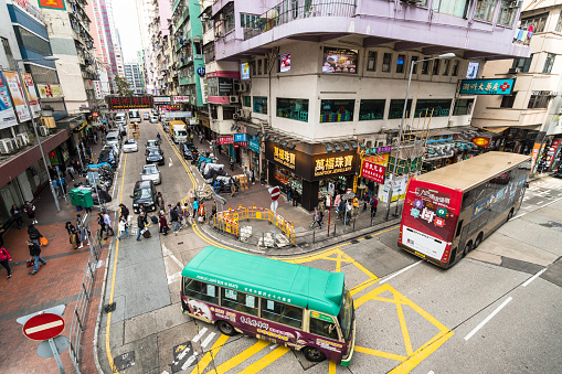 Hong Kong - January 25 2018: Aerial view of a minibus driving in the crowded streets of Mong Kok in Kowloon, Hong Kong.