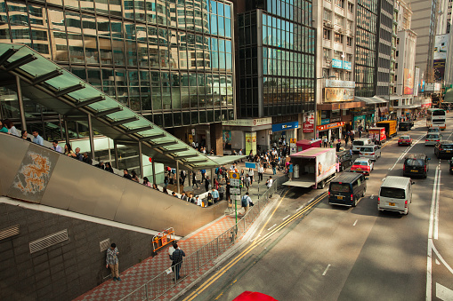 Hong Kong S.A.R., China - November 1, 2017;  everyday life; crowded city street, daily commuters, public transportation buses, delivery trucks, taxis and cars; Central island district;