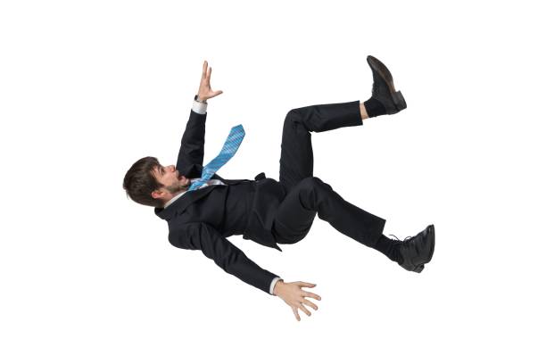 joven empresario cayendo en caída libre. aislado sobre fondo blanco. - freefall fotografías e imágenes de stock