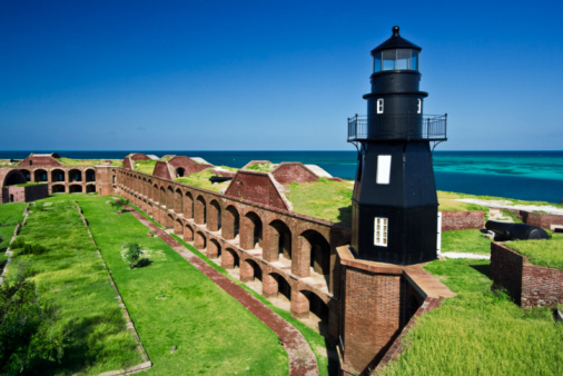 The walls of Fort Jefferson are situated on a tropical Garden Key, presently a part of Dry Tortugas National Park.