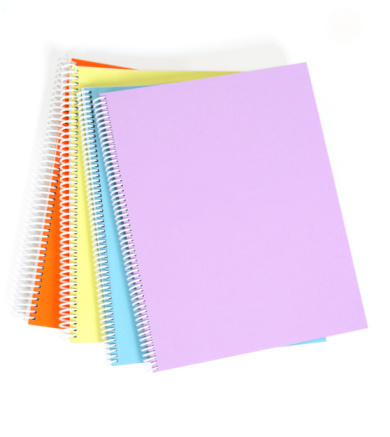 Textbooks of four different colors on white background.