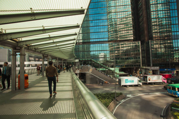 Hong Kong S.A.R., China - November 1, 2017;  everyday life; daily commuters crossing streets using elevated sky-walk; Central island area;